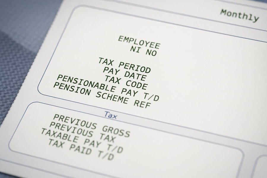Payday Printed payslip showing pay date, tax period, and pension scheme information, this represents the financial steps before pay day.